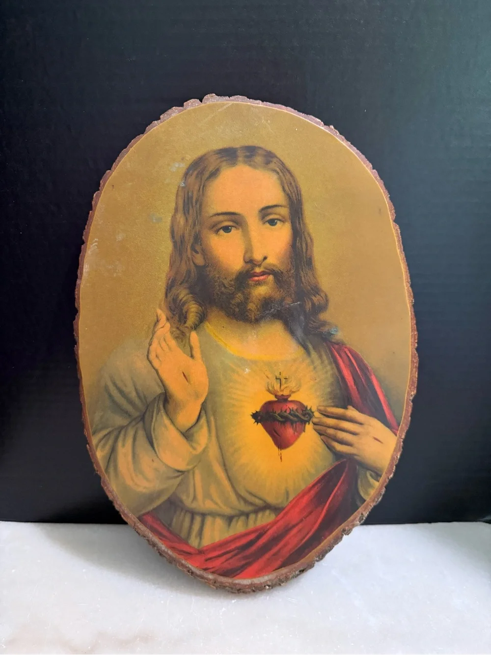 Sacred Heart of Jesus decoupaged onto an oval live-edge wood